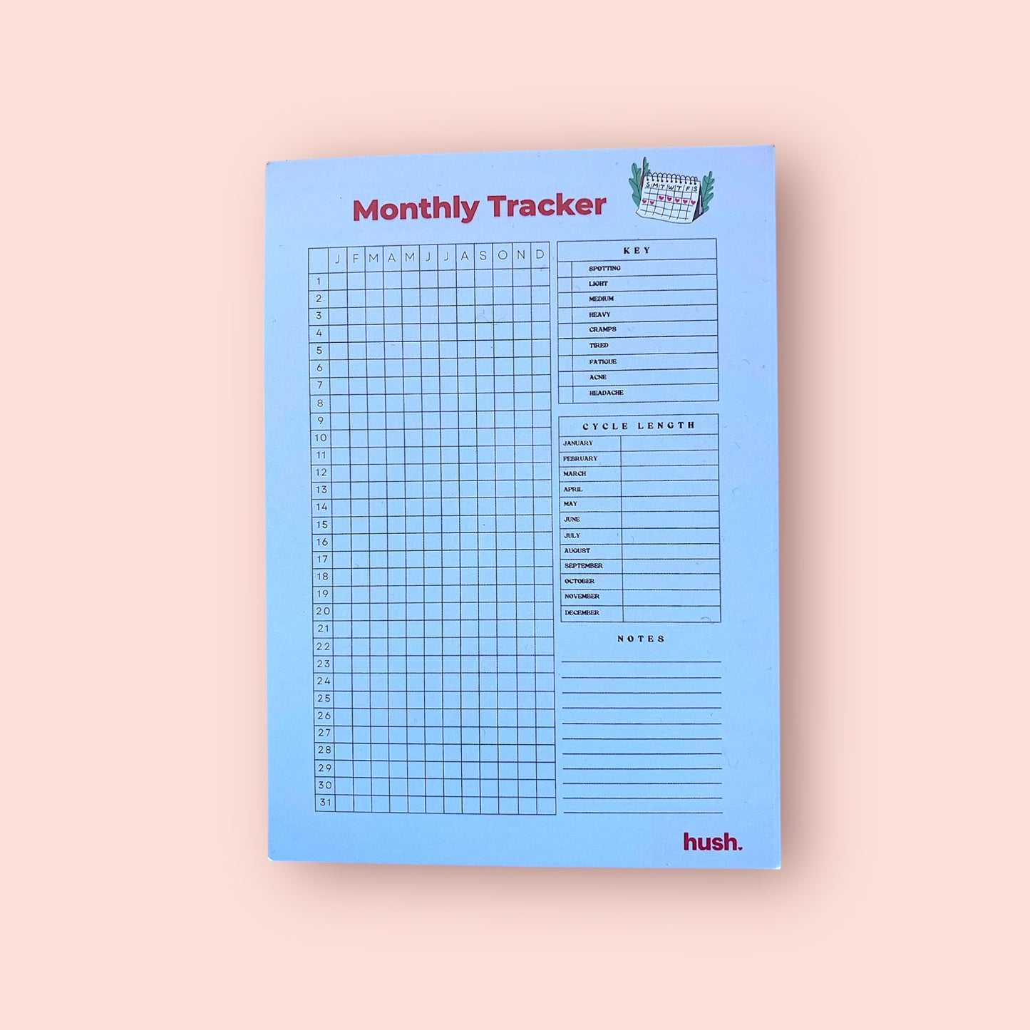 Blue monthly tracker pad with grid layout on a beige background