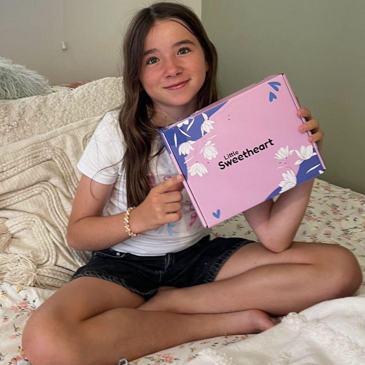 Young girl holding up the gift box