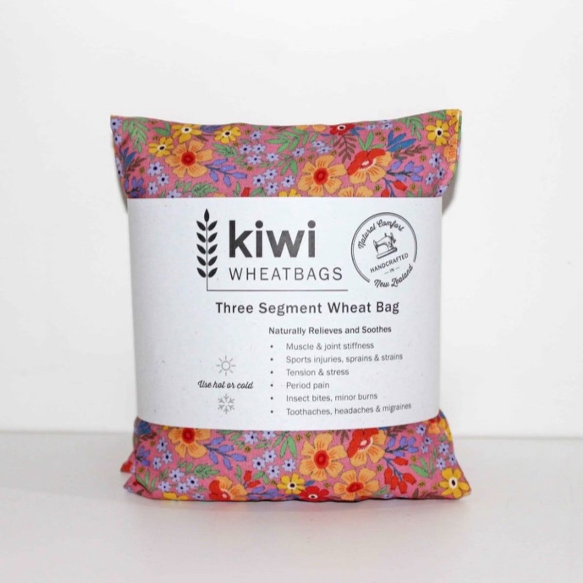 Floral-patterned three-segment wheat bag with kiwi wheatbags branding on a white background