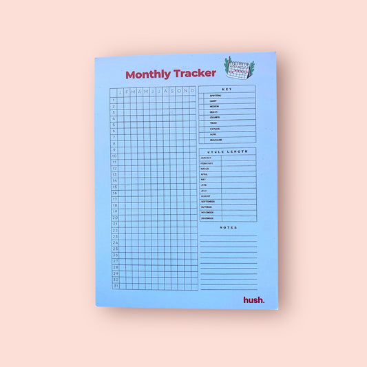 Blue monthly tracker pad with grid layout on a beige background