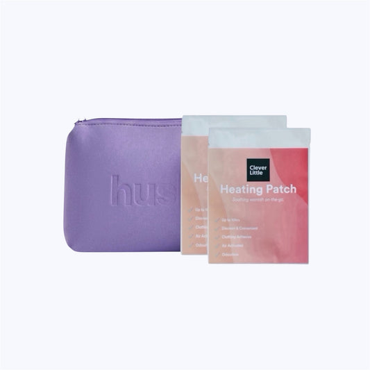 Purple pouch with hush logo embossed on it next to two clever little heat patches
