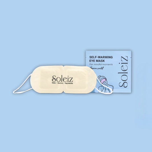 Soleiz self-warming eye mask with packaging on a light blue background