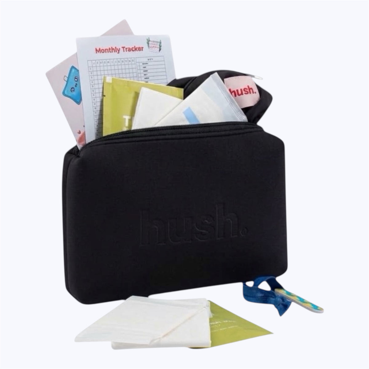 Black pouch with the logo hush embossed on it. Inside is a black wet bag, pads, wipes, monthly tracker, guide to periods , hair tie and nail file.