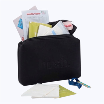 Black pouch with the logo hush embossed on it. Inside is a black wet bag, pads, wipes, monthly tracker, guide to periods , hair tie and nail file.