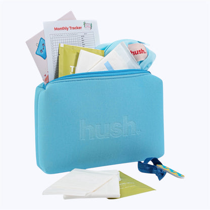 Blue pouch with hush logo embossed on it filled with period essentials including pads, wet bag, monthly tracker, wipes, nail file and hair tie.