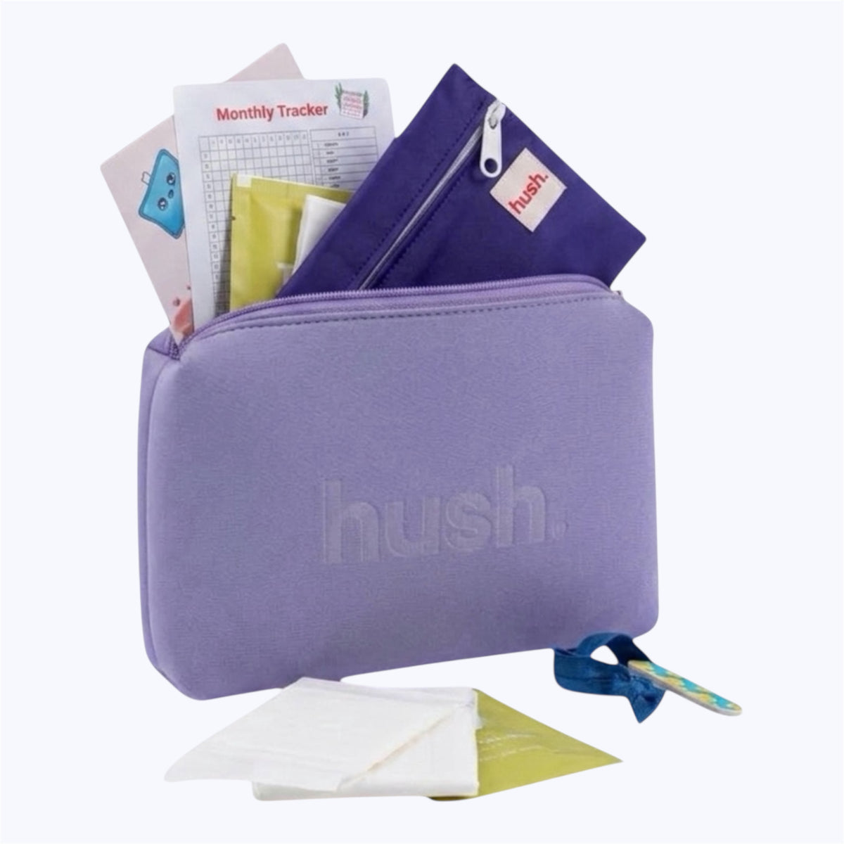 Purple pouch with hush logo embossed on it filled with period items including pads, wet bag, monthly tracker, guide to periods, wipes, hair tie and nail file.