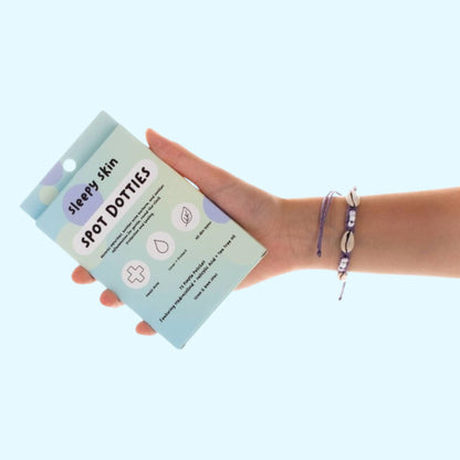 A hand holding sleepy skin pimple patches