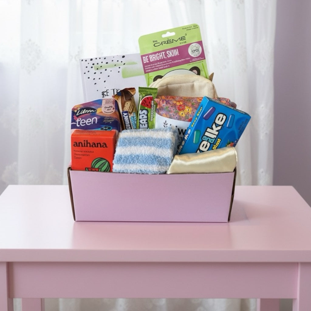Gift box full of pamper treats. Fluffy socks, shower steamer, wheat bag, gratitude journal, American treat. 
