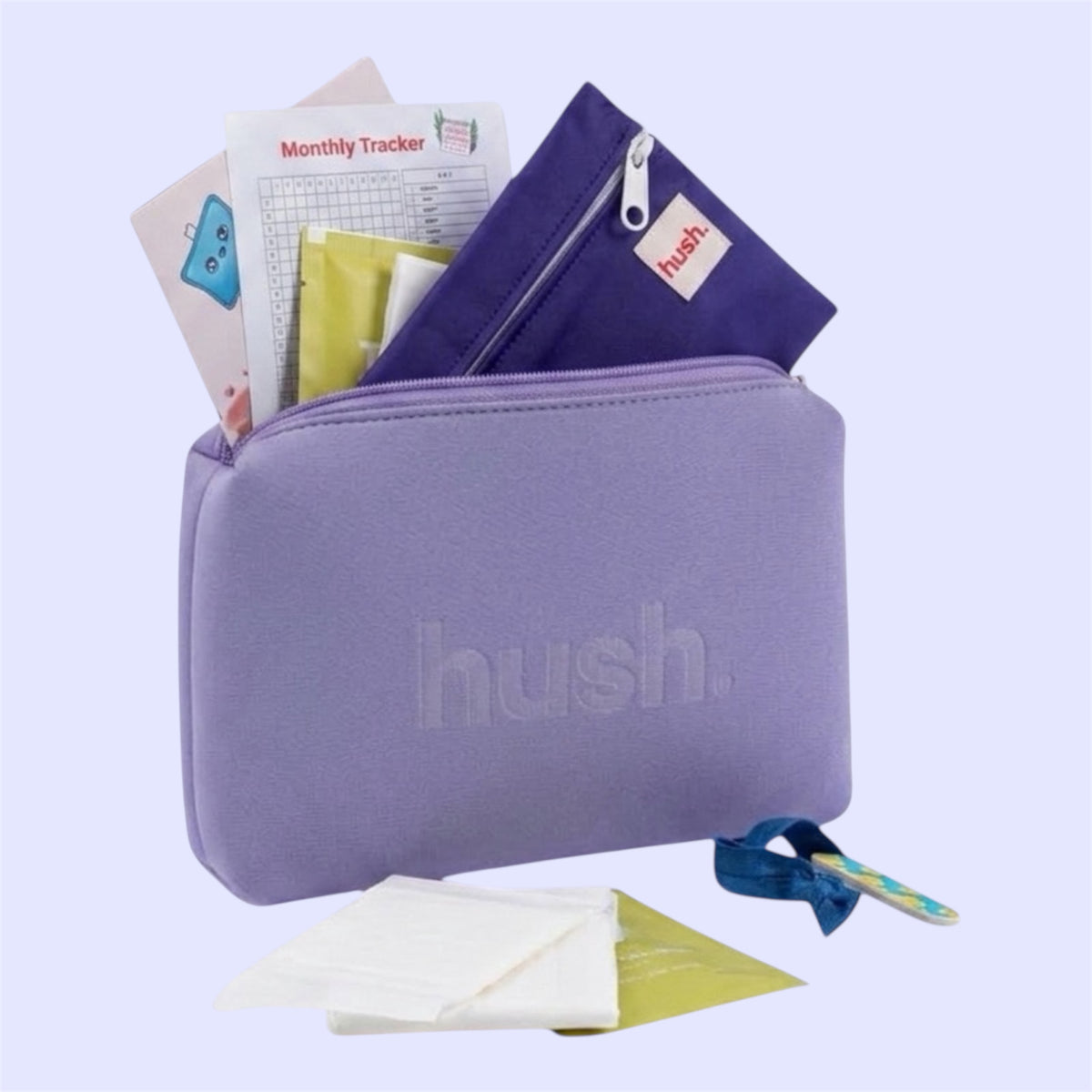 A  purple zippered pouch with the brand name 'hush.' embossed on the front, shown open with various period accessories  including a purple wet bag, a monthly tracker , pads and antibacterial wipes.